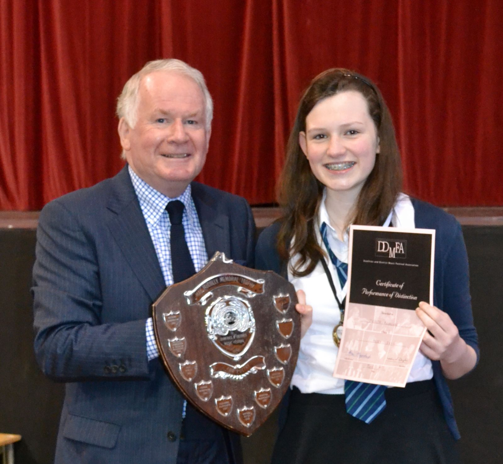 Class 8 Adjudicator Brian Marjoribanks presents trophy to winner Elspeth Nicholson Wallace Hall Academy