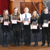 Class 17 adjudicator Brian Marjoribanks presenting a trophy to Justine Crosbie Lucy Doig Nathan King Mia Osborne and Kieran Watson